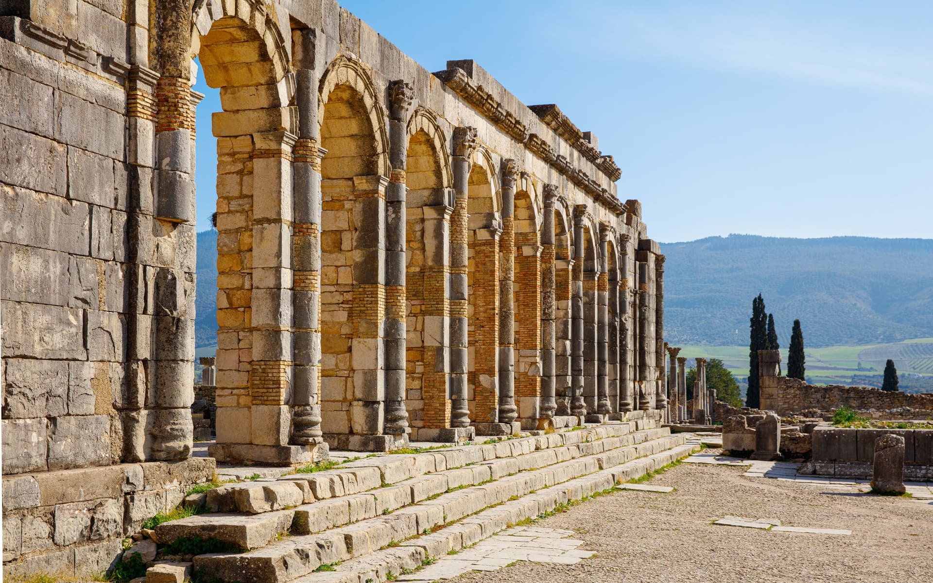 Ruinas romanas de Volubilis en Marruecos, basílica con arcos y columnas de piedra Patrimonio UNESCO